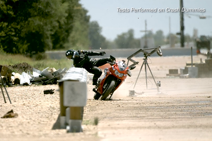 Dummy simulations of a motorcyclist falling off motorcycle into a guardrail