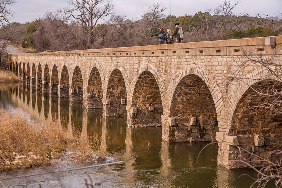 People looking out Texas historic bridge