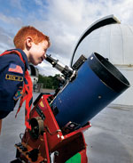 boyscout looking through telescope