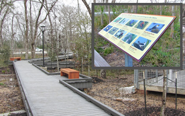 The facility features elevated walkways with interpretive displays