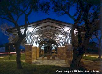 The tree-like roofing structure of a picnic arbor seems to rhyme with the existing live oak trees