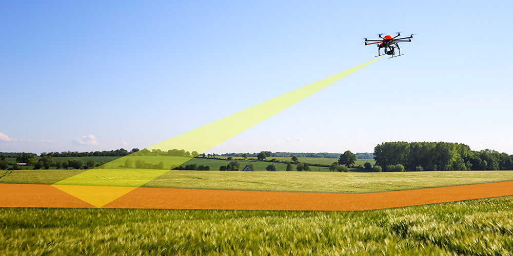 Drone following flight path over field