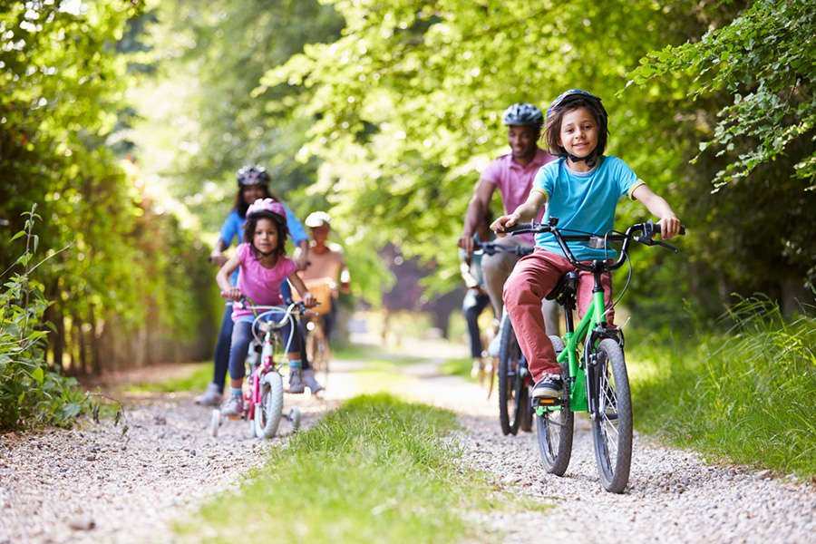 Family riding bicycles on trail