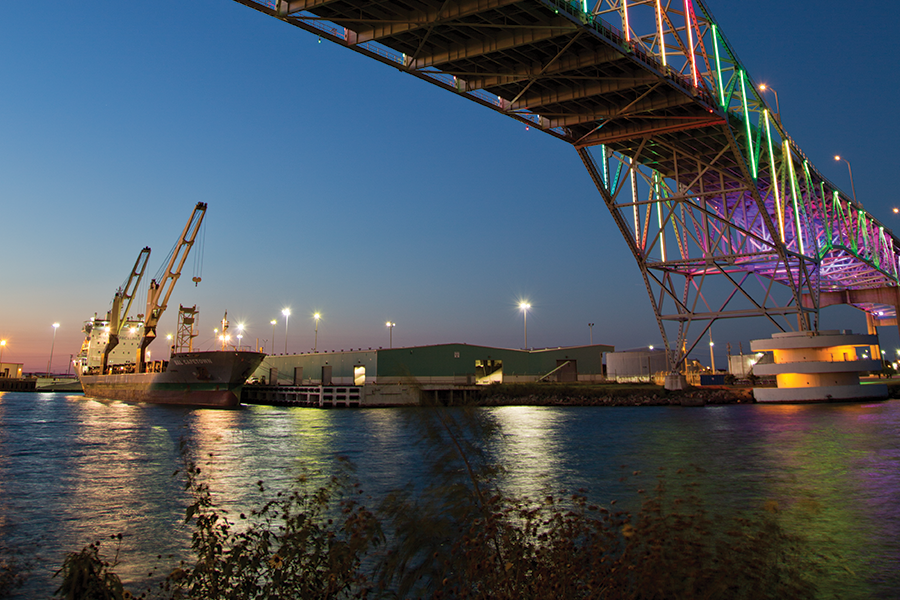 harbor bridge at night with ship