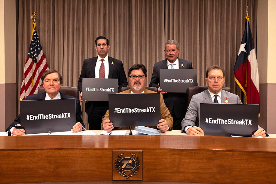 Commissioners with EndTheStreak signage