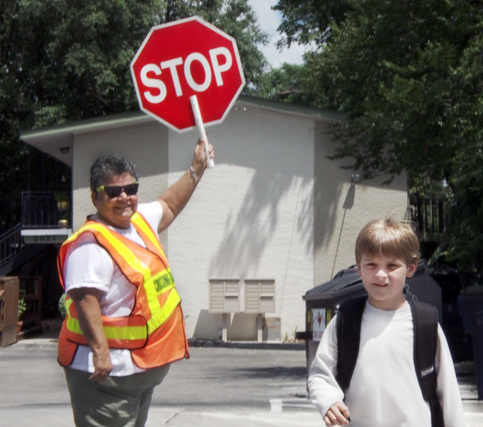Child and crossing guard smiling