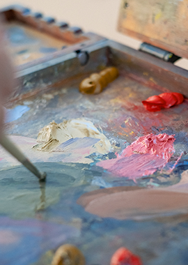 Close up paintbrush mixing colors