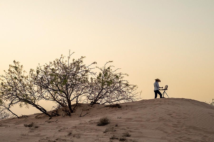 Person standing on sand dune painting