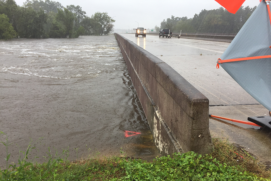 Light traffic on a bridge during a flood event.