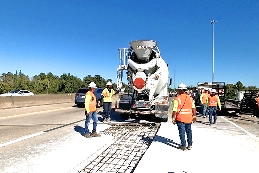 A maintenance crew makes repairs on a bridge. 