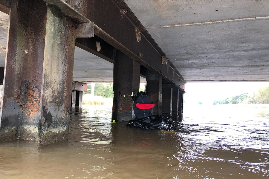 A TxDOT diver conducts an underwater inspection of bridge supports.
