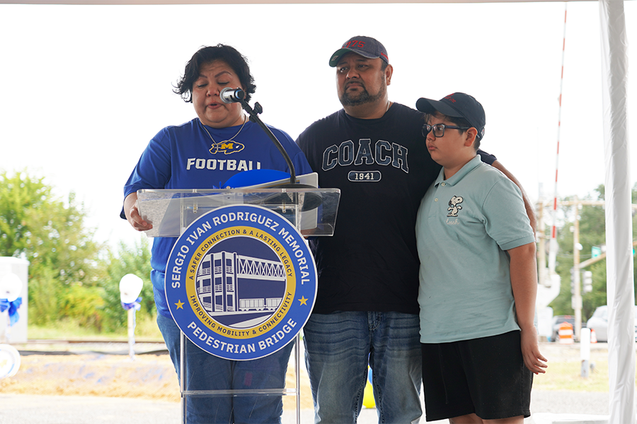 The family of Sergio Ivan Rodriguez attend the groundbreaking of the memorial pedestrian bridge being built in their son's memory. Sergio's father and younger brother stand near by, as his mother address the crowd. 