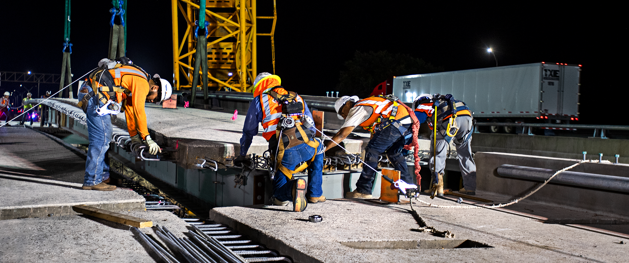 Construction workers with bridge beam