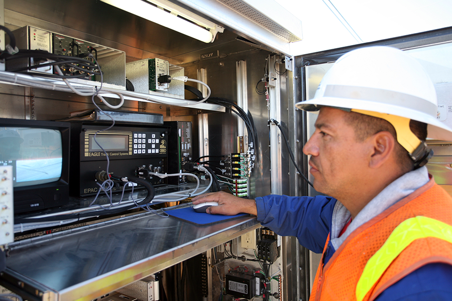 Electrical worker adjusting signal equipment