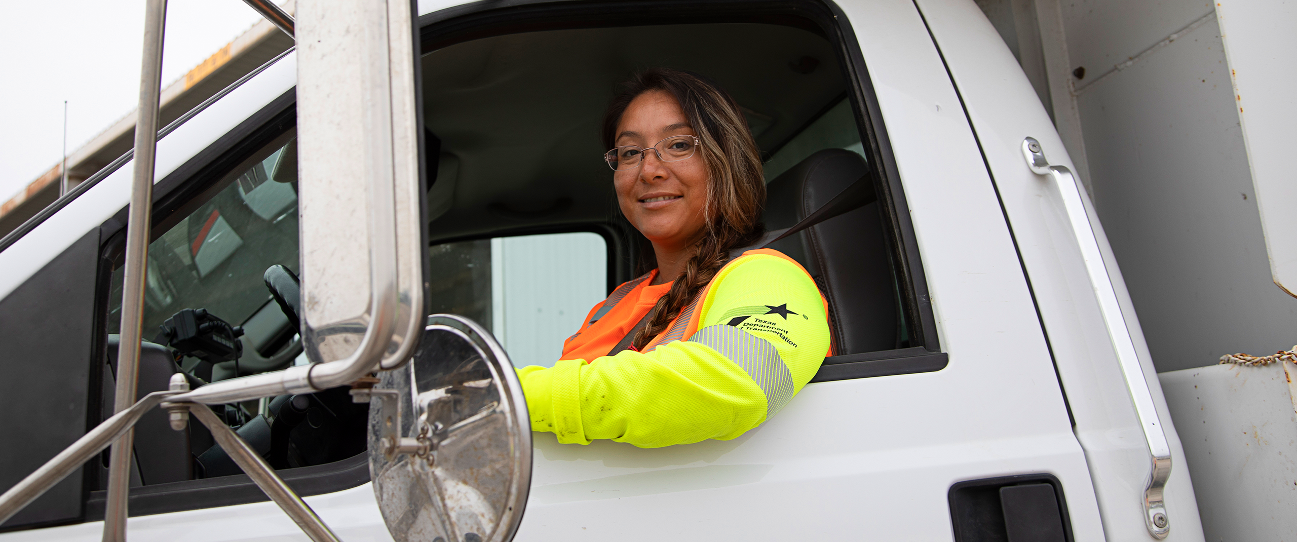 Female TxDOT employee driving truck