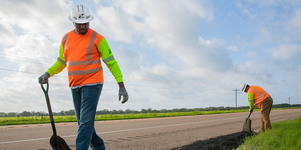Workers repair asphalt