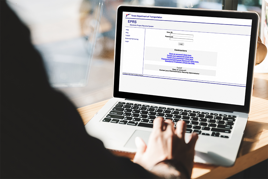Person on laptop accessing electronic project record system