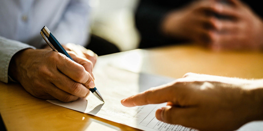 Person signing a contract