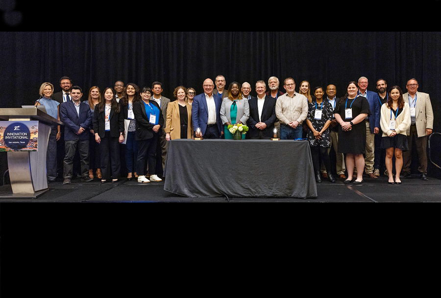 Participating teams join hosts and judges on stage at the 2024 Innovation Invitational.