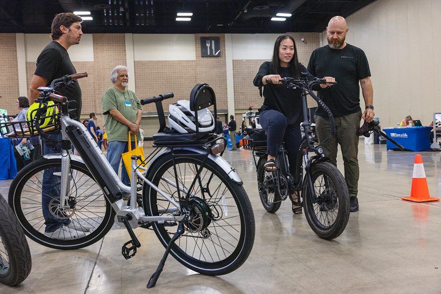 An attendee at the conference tests and e-bike at the Tech Showcase. 