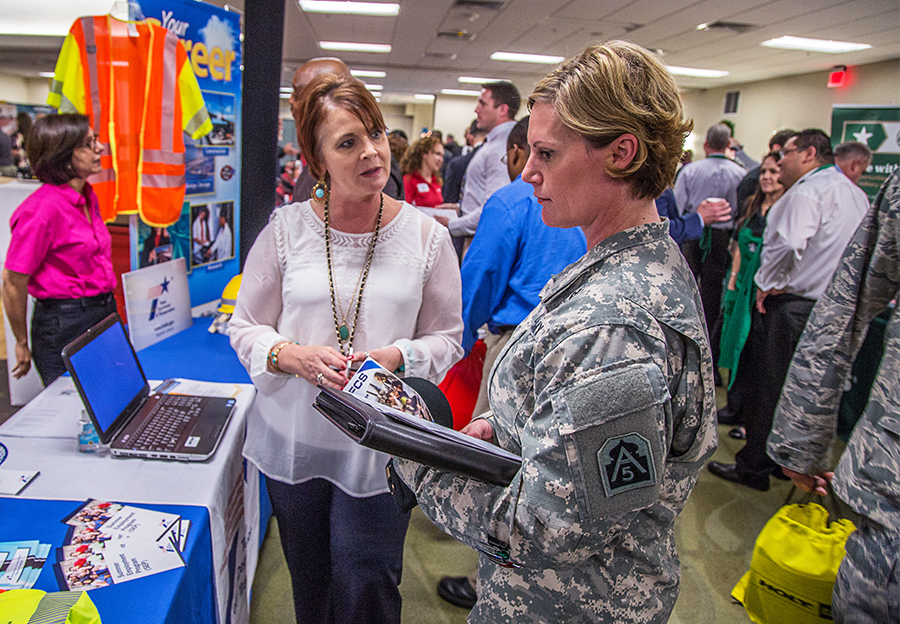 Female veteran speaking with TxDOT employee at job fair