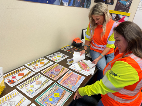 Judges reviewing hand-colored artwork Judges reviewing hand-colored artwork for Work Zone Awareness contest.