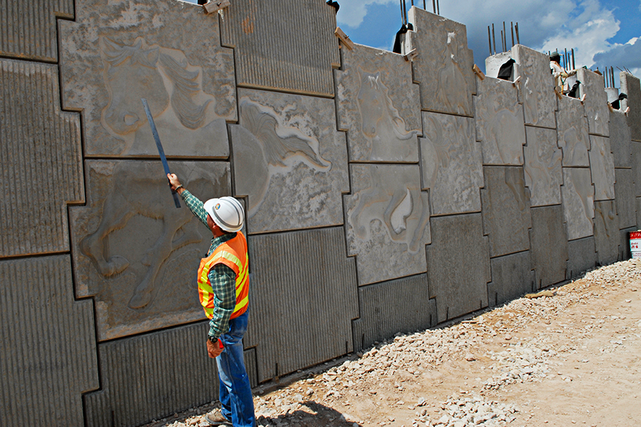 Worker standing by retaining wall