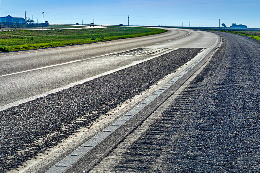 Asphalt texture with rumble strips