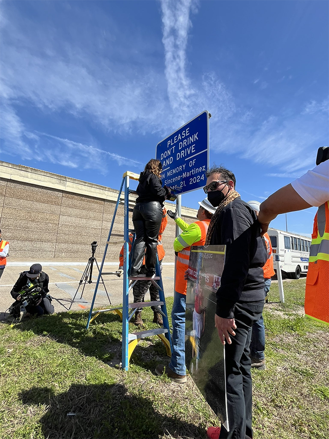 Family helping put up memorial marker Family members assist TxDOT workers in putting up memorial marker