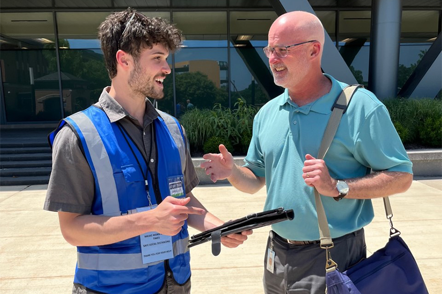 Worker engaging person for survey at establishment