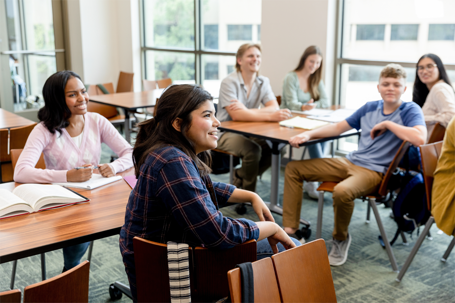 The students draw their attention to the unseen professor who is talking at the front of the class.