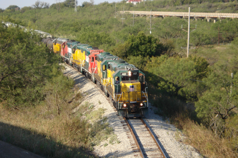 Train moving through forest