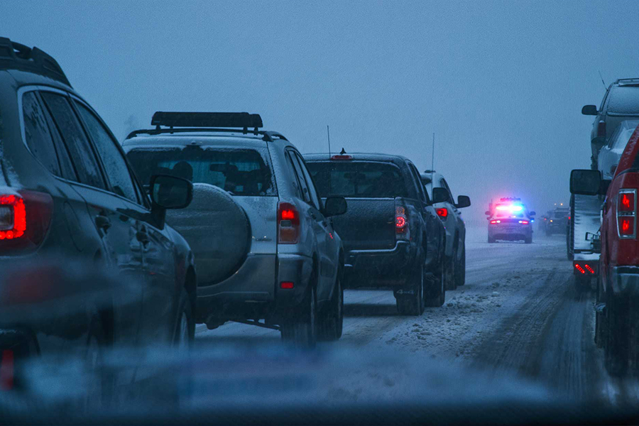 Vehicles on icy road behind police car