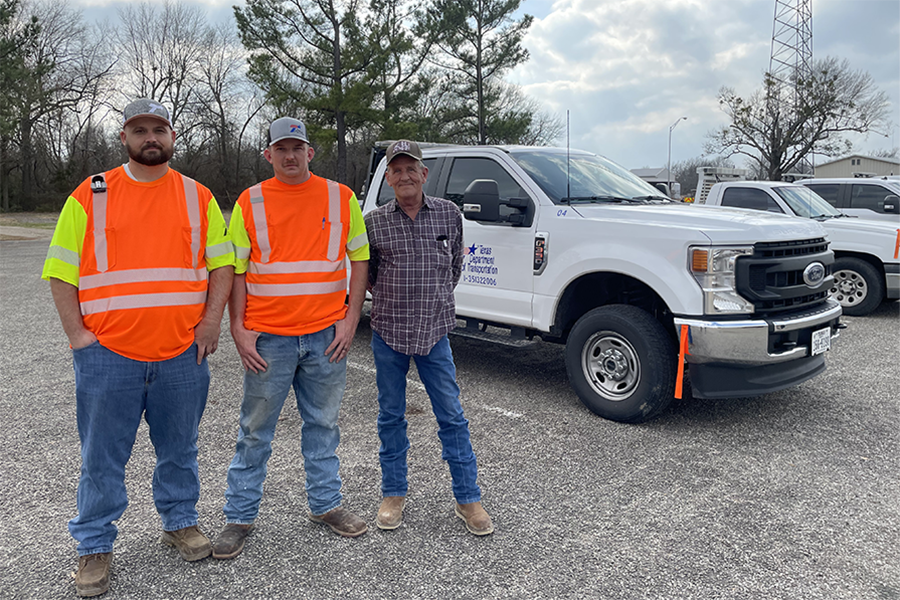 TxDOT workers standing by TxDOT work truck