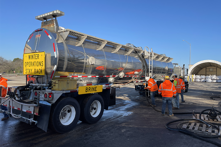 De-icing brine truck with TxDOT workers.