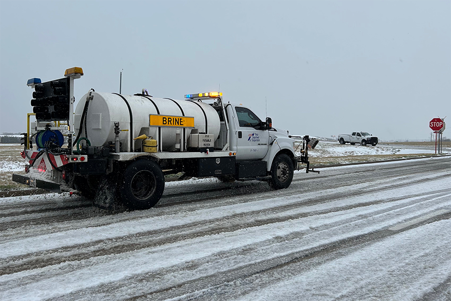 Pharr team in Dallas with truck spreading brine