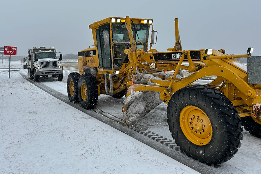 Snow plow and truck clearing roads in Dallas.