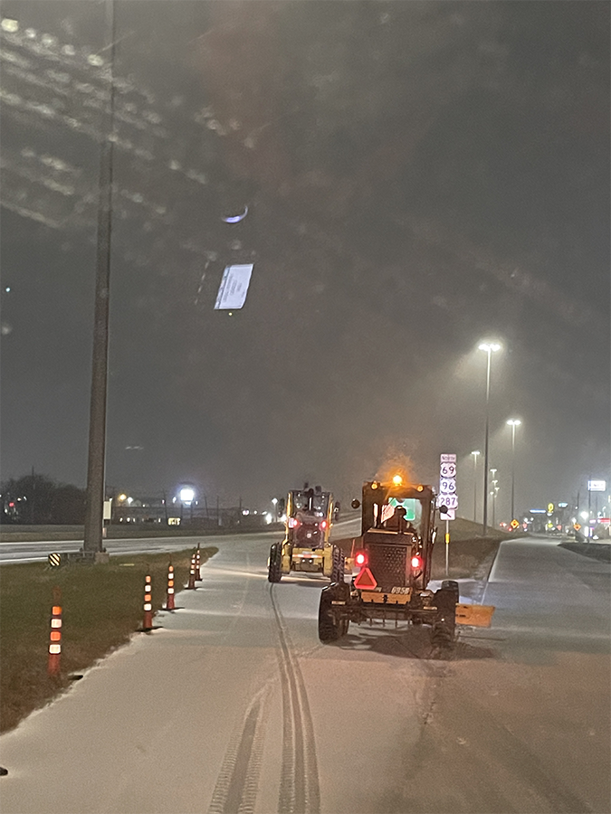 Plows on snowy highway entrance ramps