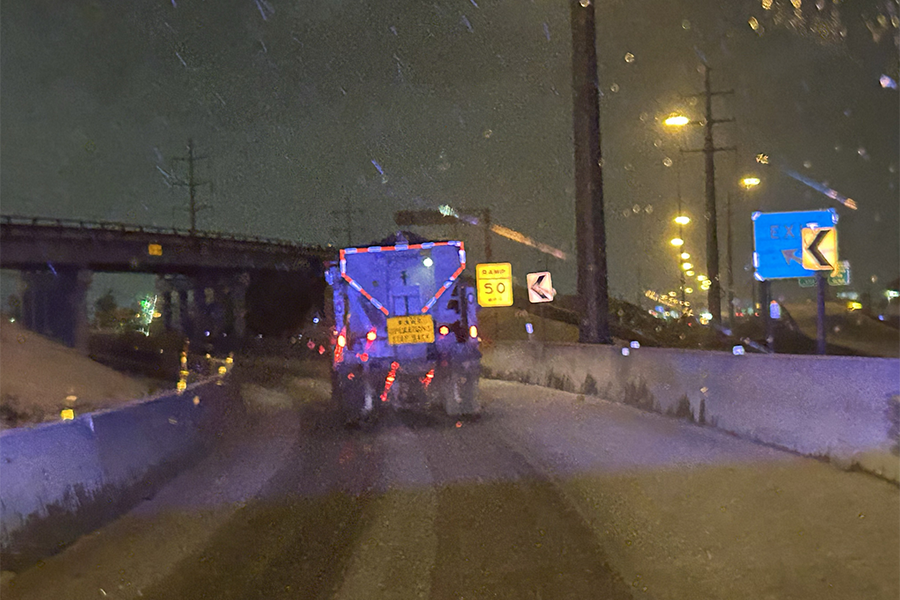 Work truck on highway in heavy snow and sleet.