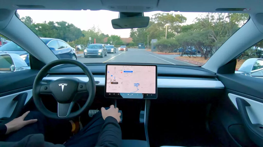 driver view of hands-free driving in Tesla on road