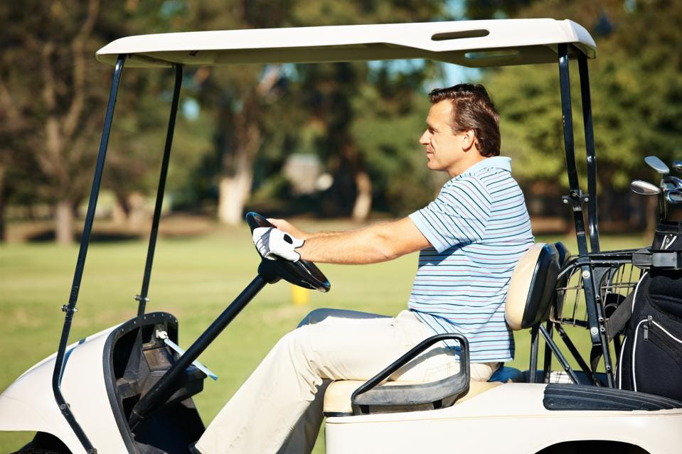 man driving golf cart