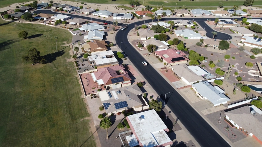 aerial view of neighborhood with car on road