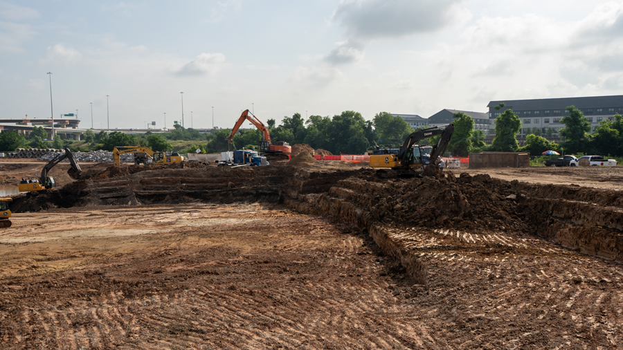 Multiple Crews Placing Soil into Trucks 