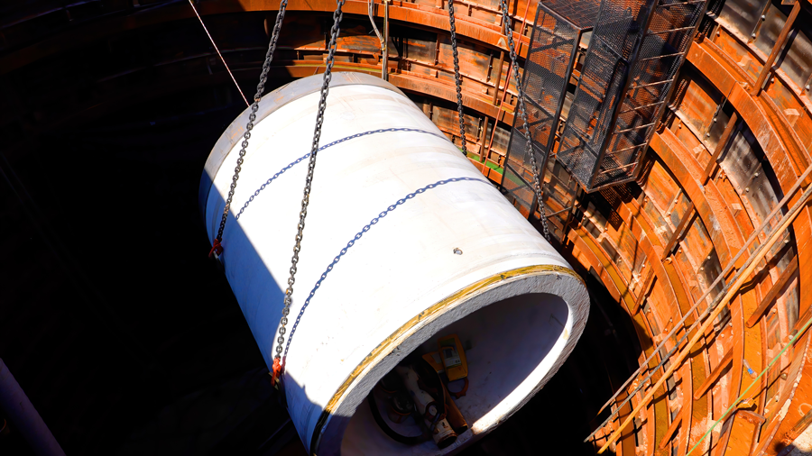 Pipe begins descent into 50-foot deep pit