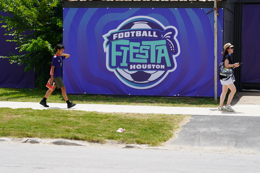 Family walking toward the Fan Fest on new St. Emanuel temporary sidewalk near Clay Street