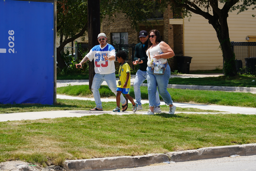 Fans walking on new temporary sidewalk along St. Emanuel near Polk Street