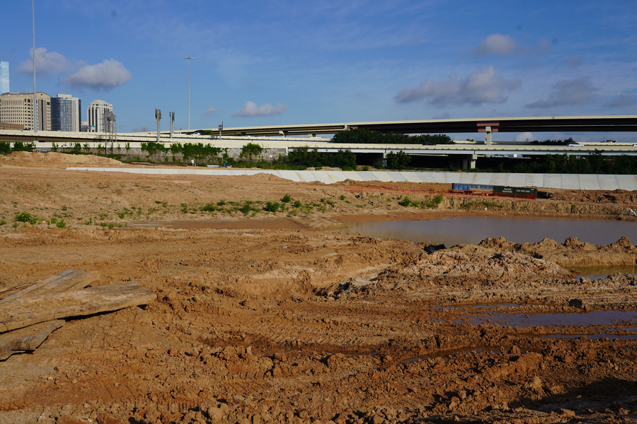Concrete at western edge of detention pond visible in background