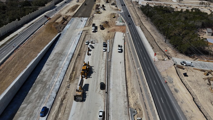 Oak Hill Parkway crews use a large paver to pour and flatten concrete for future westbound US 290 mainlanes and exit ramp just west of Scenic Brook Drive.  Use of recycled materials from the old US 290 & SH 71 roadway surfaces helps divert construction waste from landfills and conserve new resources. 