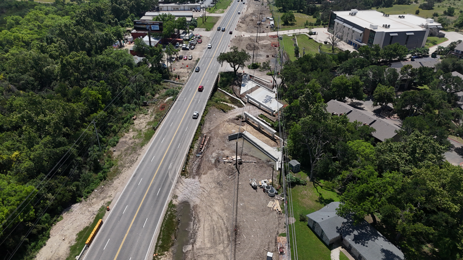Crews construct a bridge over Williamson Creek. June 2024.