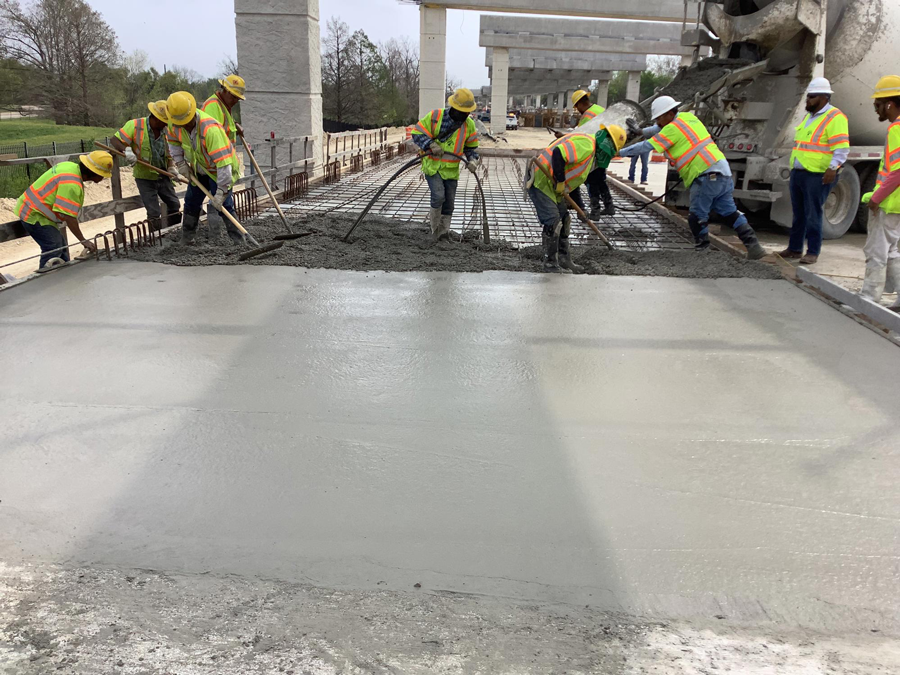 Crews place concrete for a shared-use path. March 2024.